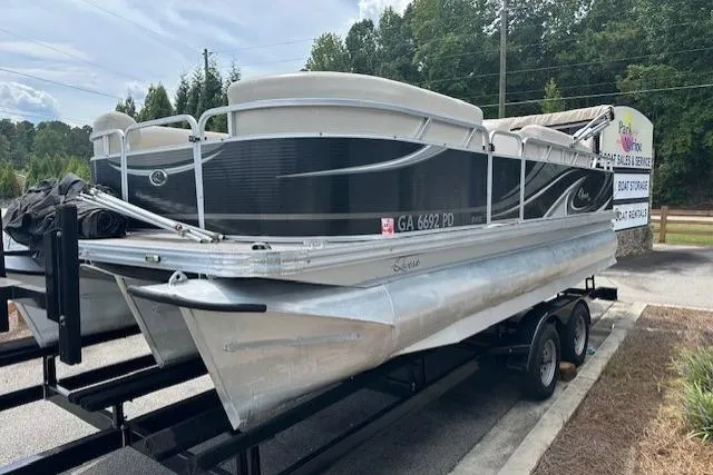 Slide: The Image of 2014 Qwest LS 820 XRE Cruise pontoon boat on trailer, parked outdoors. - 2