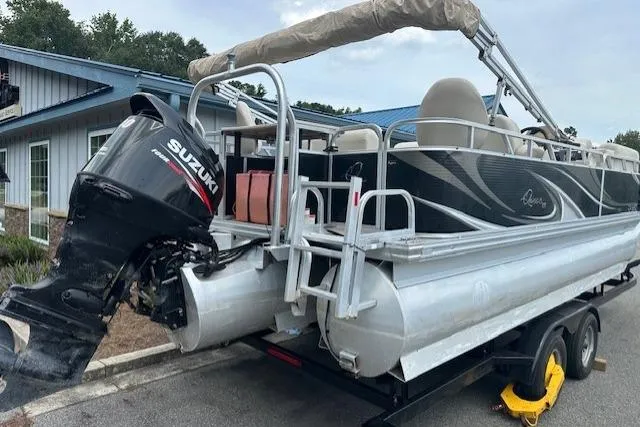 Slide: The Image of 2014 Qwest LS 820 XRE Cruise pontoon boat with Suzuki outboard motor on trailer. - 4