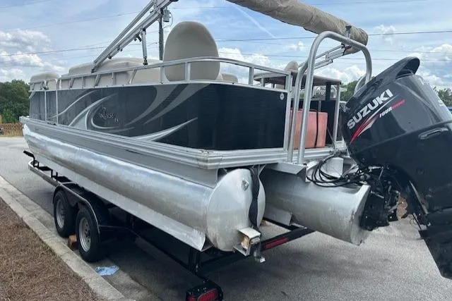 Slide: The Image of 2014 Qwest LS 820 XRE Cruise pontoon boat with Suzuki outboard motor on trailer. - 5
