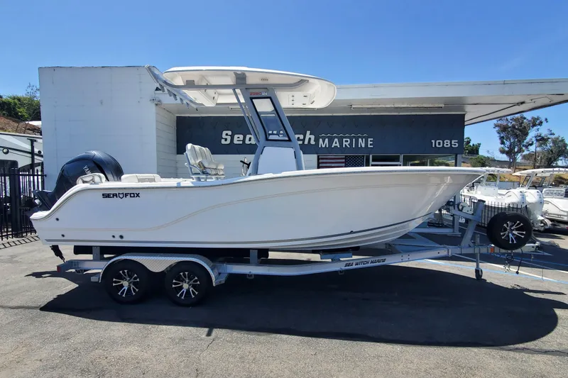 The Image of 2025 Sea Fox 228 Commander boat on trailer at dealership, side view. - 0