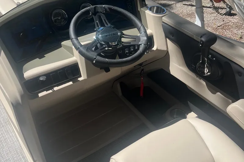Slide: The Image of 2026 Avalon 25 LSZ Quad Lounger boat interior with steering wheel and controls. - 3