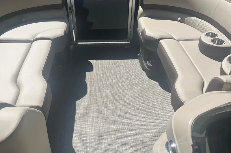 Slide: The Image of 2026 Avalon 25 LSZ Quad Lounger interior with luxurious seating and cup holders. - 4