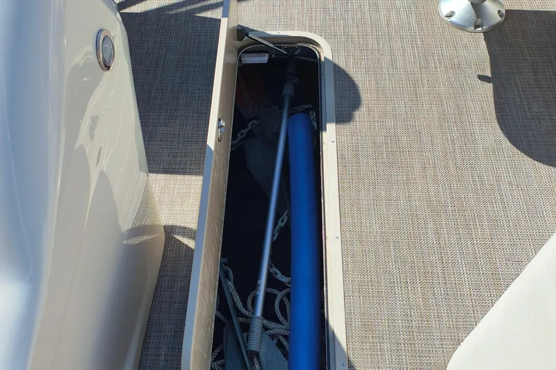 Slide: The Image of 2022 Avalon Catalina Quad Lounge 25 storage compartment with ropes and equipment. - 11