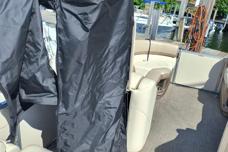 Slide: The Image of 2022 Avalon Catalina Quad Lounge 25 interior with beige seating and black cover. - 15