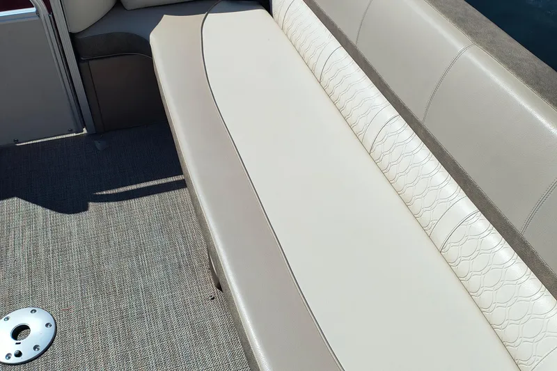Slide: The Image of 2022 Avalon Catalina Quad Lounge 25 interior seating with textured upholstery and carpeted flooring. - 19