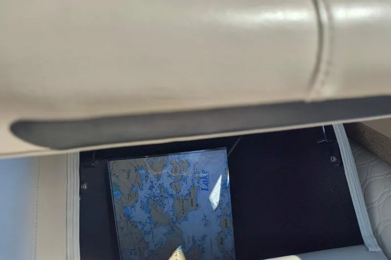 Slide: The Image of Storage compartment in 2022 Avalon Catalina Quad Lounge 25 with a map inside. - 24