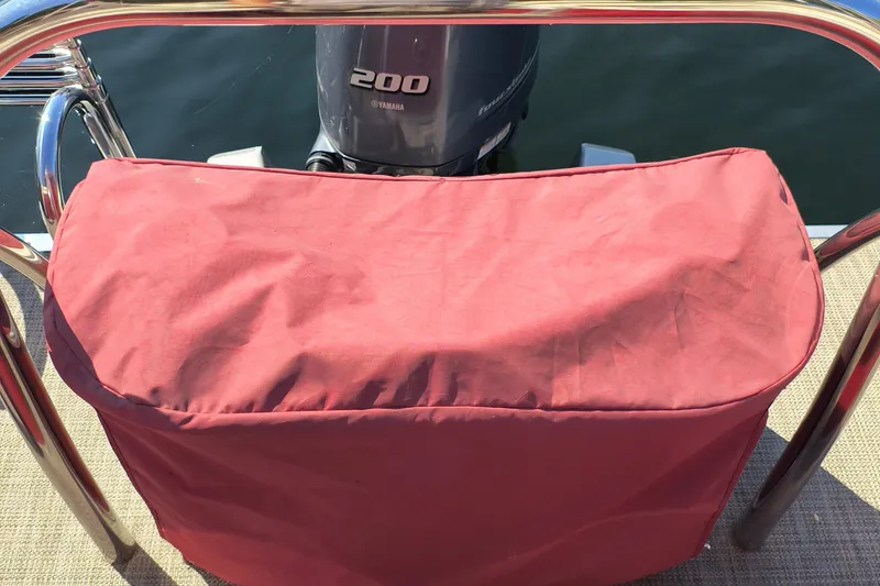 Slide: The Image of 2022 Avalon Catalina Quad Lounge 25 with Yamaha 200 engine, red cover, and chrome railing. - 26