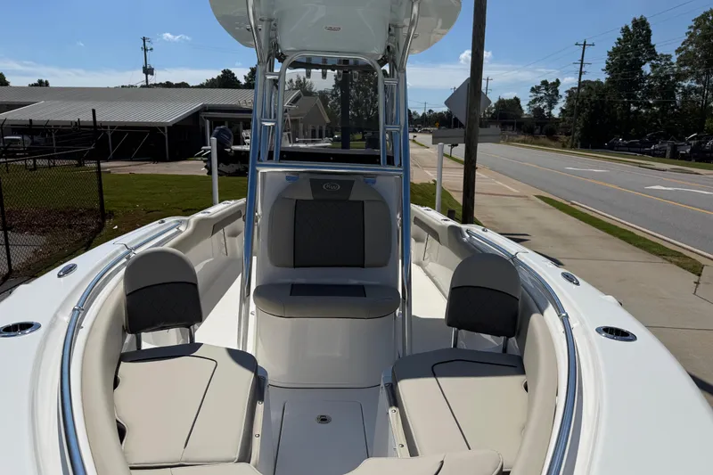 Slide: The Image of 2026 Key West 239 FS boat interior with seating, parked near a road. - 13