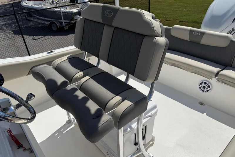 Slide: The Image of 2026 Key West 239 FS boat interior with cushioned seating and steering wheel. - 18