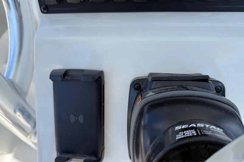 Slide: The Image of 2026 Key West 239 FS boat dashboard with wireless charging pad and Seastar control. - 25