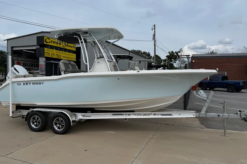 Slide: The Image of 2026 Key West 239 FS boat on trailer outside dealership. - 3