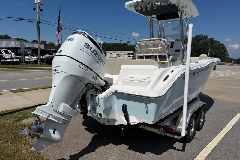Slide: The Image of 2026 Key West 239 FS boat with Suzuki engine on trailer, parked roadside. - 40