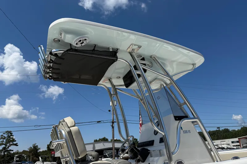 Slide: The Image of 2026 Key West 239 FS boat with T-top and rod holders under a clear blue sky. - 43
