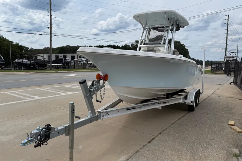 Slide: The Image of 2026 Key West 239 FS boat on trailer, parked outdoors, under cloudy sky. - 5