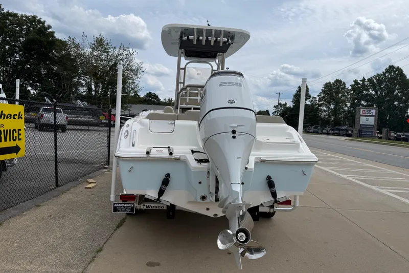 Slide: The Image of 2026 Key West 239 FS boat with powerful outboard motor, parked on a concrete surface. - 7