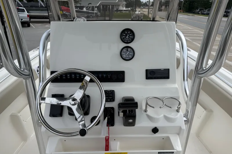 Slide: The Image of 2026 Key West 239 FS boat dashboard with steering wheel and controls. - 9