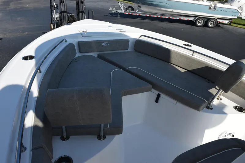 Slide: The Image of 2026 Sea Hunt Ultra 229 boat interior with gray seating and stainless steel fixtures. - 11