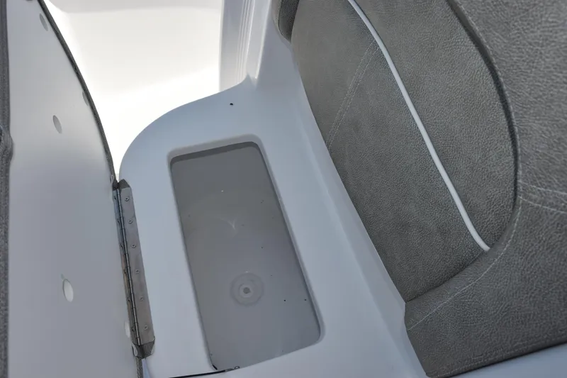 Slide: The Image of Storage compartment in 2026 Sea Hunt Ultra 229 boat, featuring gray cushioned seating. - 13