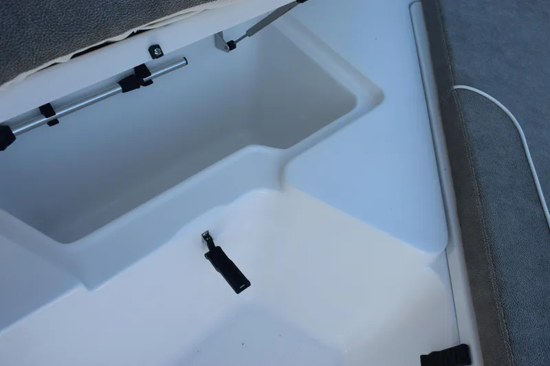 Slide: The Image of Storage compartment on 2026 Sea Hunt Ultra 229 boat, featuring secure latches and cushioned seating. - 14