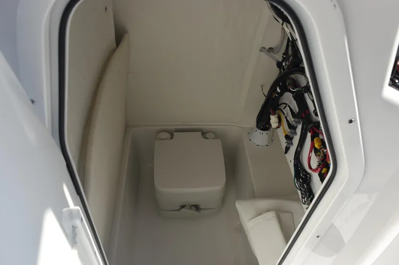 Slide: The Image of Interior of 2026 Sea Hunt Ultra 229 boat, featuring compact storage space. - 15