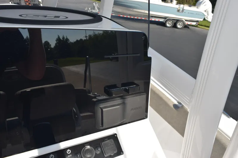 Slide: The Image of 2026 Sea Hunt Ultra 229 boat dashboard with Fusion audio system and controls. - 17