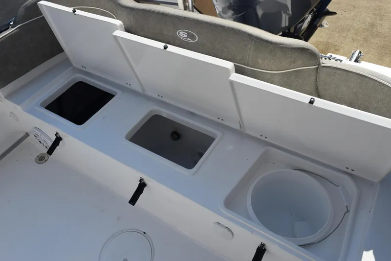 Slide: The Image of 2026 Sea Hunt Ultra 229 boat storage compartments and seating area. - 18