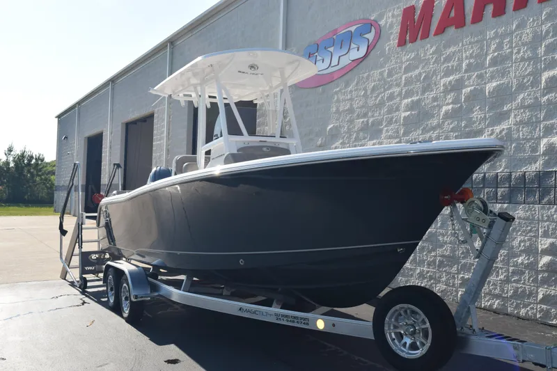 Slide: The Image of 2026 Sea Hunt Ultra 229 boat on trailer outside marine dealership. - 2
