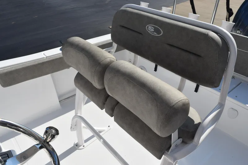 Slide: The Image of 2026 Sea Hunt Ultra 229 boat seating with gray cushioned backrest and white frame. - 9