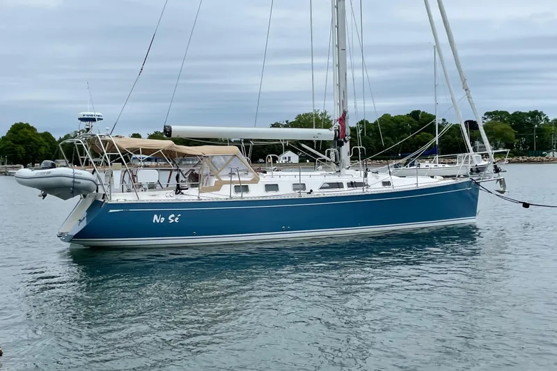 The Image of Blue 2004 Saga 43CLS sailboat named "No Sé" anchored on calm water. - 0