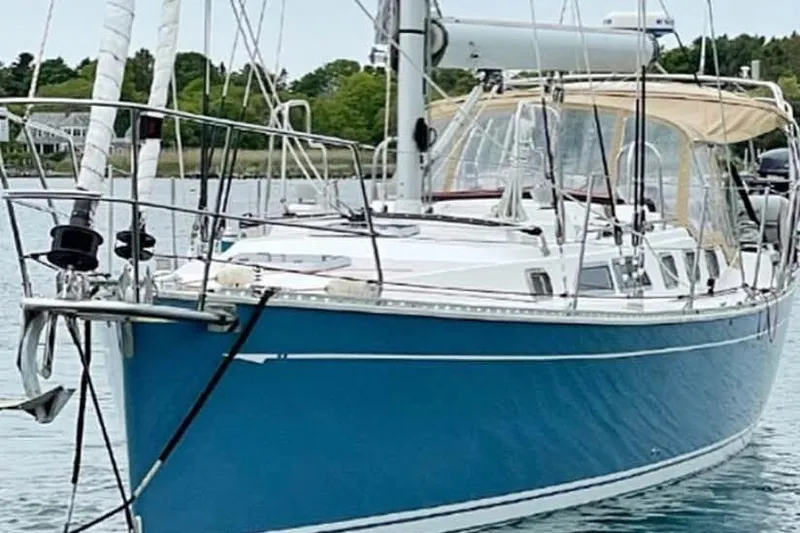 Slide: The Image of Blue 2004 Saga 43CLS sailboat docked on calm water. - 2