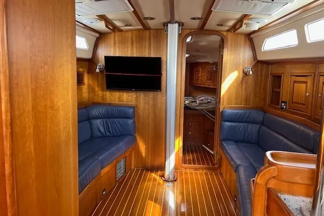 Slide: The Image of Interior of 2004 Saga 43CLS yacht with wooden finish and blue seating. - 4