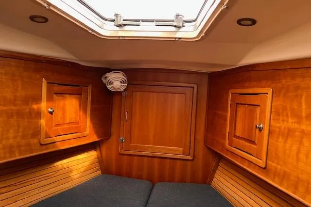 Slide: The Image of Cozy cabin interior of 2004 Saga 43CLS sailboat with wooden paneling and skylight. - 5
