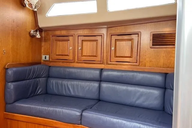 Slide: The Image of Interior of 2004 Saga 43CLS yacht with blue leather seating and wooden cabinets. - 6