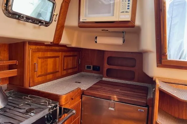 Slide: The Image of Cozy kitchen in 2004 Saga 43CLS yacht with wooden cabinetry and modern appliances. - 7
