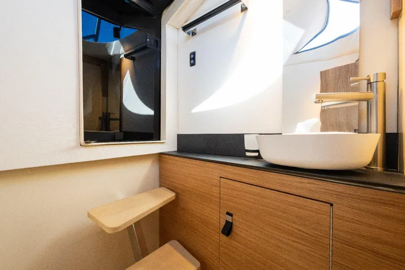 Slide: The Image of Modern bathroom interior in AlCustom LIPARI 31 yacht, featuring sleek sink and wooden cabinetry, 2025 model. - 22