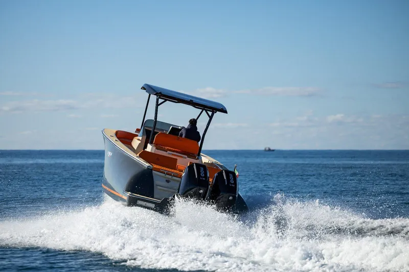 Slide: The Image of 2025 AlCustom LIPARI 31 boat cruising on open water, creating a wake. - 4