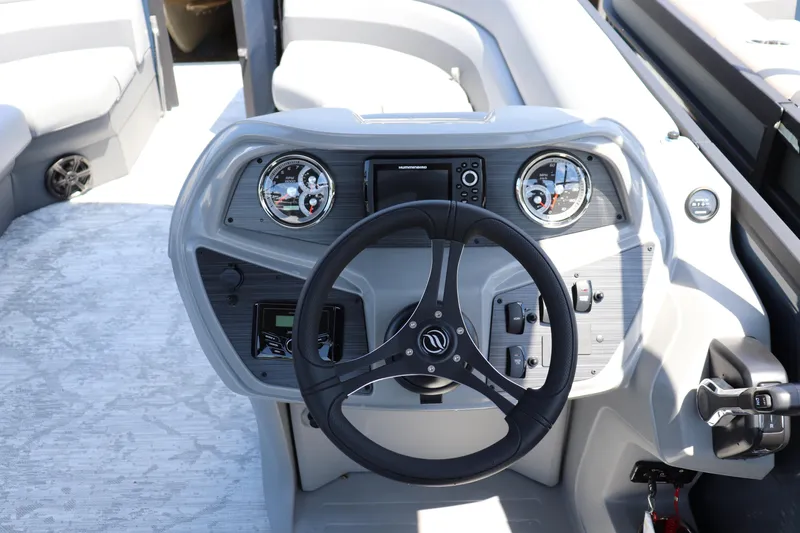 Slide: The Image of 2025 Flagship Freedom 20 CU Tritoon dashboard with steering wheel and controls. - 5