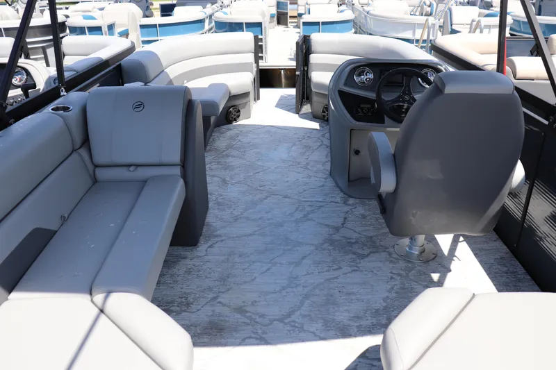 Slide: The Image of 2025 Flagship Freedom 20 CU Tritoon interior with gray seating and modern dashboard. - 8