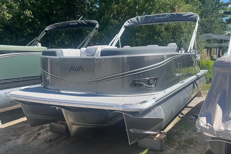 The Image of 2026 Avalon 23 Quad Lounger pontoon boat in a sunny outdoor setting. - 1