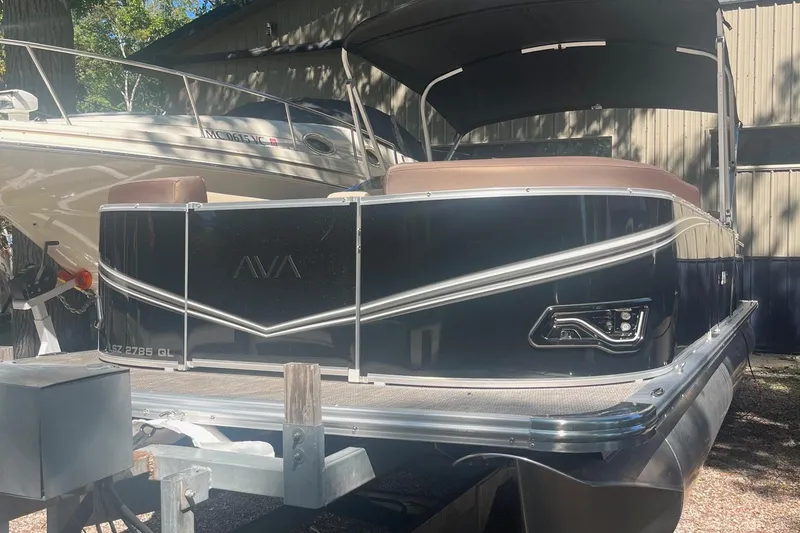Slide: The Image of 2026 Avalon 23 Quad Lounger pontoon boat in storage, featuring sleek design and modern amenities. - 10