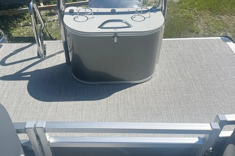 Slide: The Image of 2026 Avalon 23 Quad Lounger boat deck with sleek console and cup holders. - 3