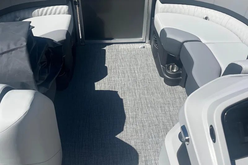 Slide: The Image of 2026 Avalon 23 Quad Lounger interior with gray seating and carpet flooring. - 6