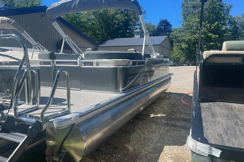 Slide: The Image of 2026 Avalon 23 Quad Lounger pontoon boat parked outdoors on gravel. - 7