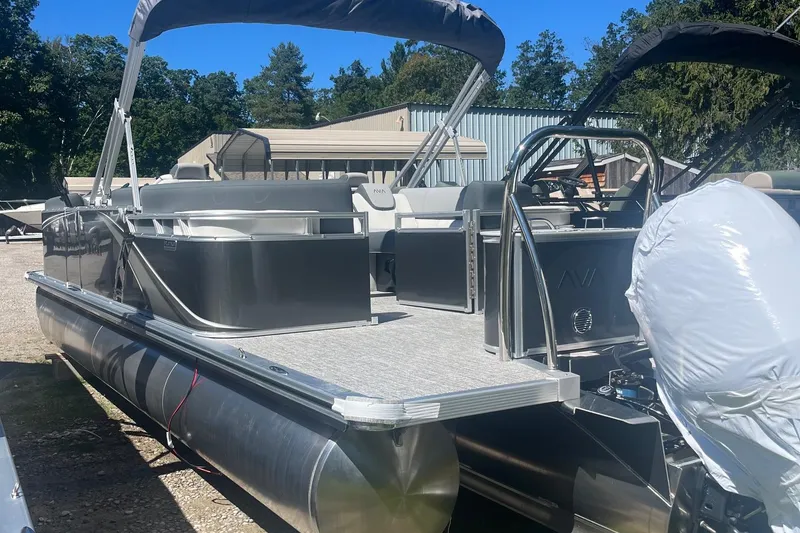 Slide: The Image of 2026 Avalon 23 Quad Lounger pontoon boat with sleek design, parked outdoors. - 8