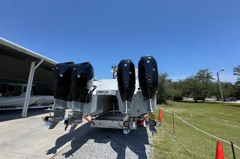 Slide: The Image of 2026 Invincible 46 Catamaran with four powerful outboard engines, parked outdoors. - 11