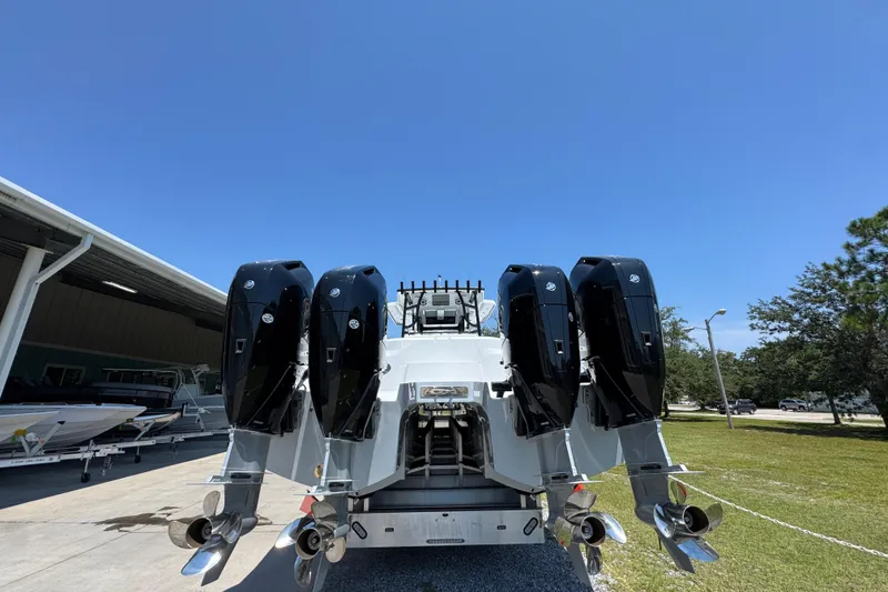 Slide: The Image of 2026 Invincible 46 Catamaran with four powerful outboard engines, parked outdoors. - 12