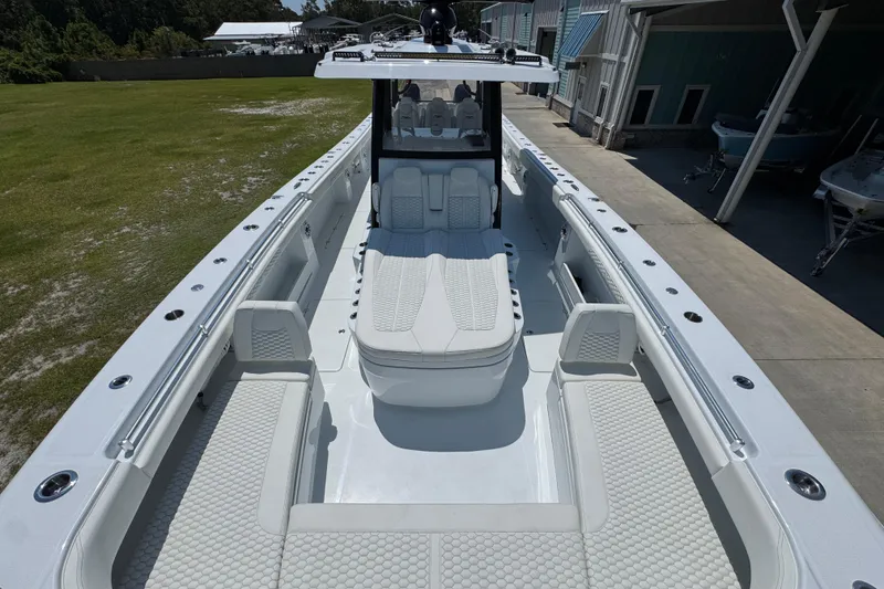 Slide: The Image of 2026 Invincible 46 Catamaran with spacious deck and luxurious seating in marina setting. - 18