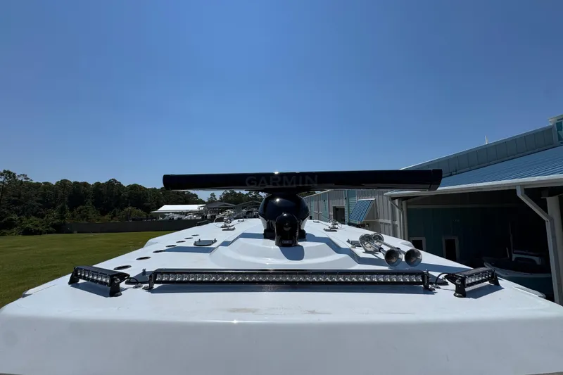 Slide: The Image of 2026 Invincible 46 Catamaran with Garmin equipment on deck, under clear blue sky. - 20