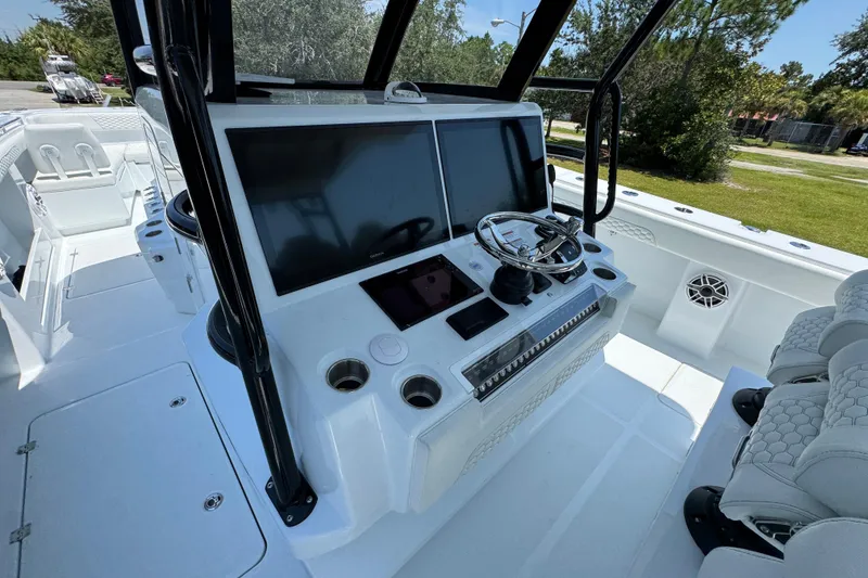 Slide: The Image of 2026 Invincible 46 Catamaran helm with dual screens and modern controls. - 30