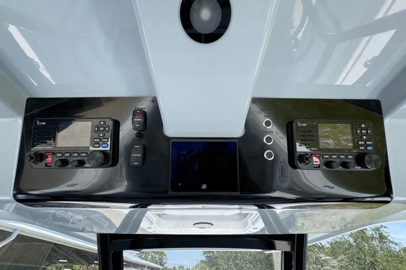 Slide: The Image of Control panel of 2026 Invincible 46 Catamaran featuring Icom marine radios and switches. - 33